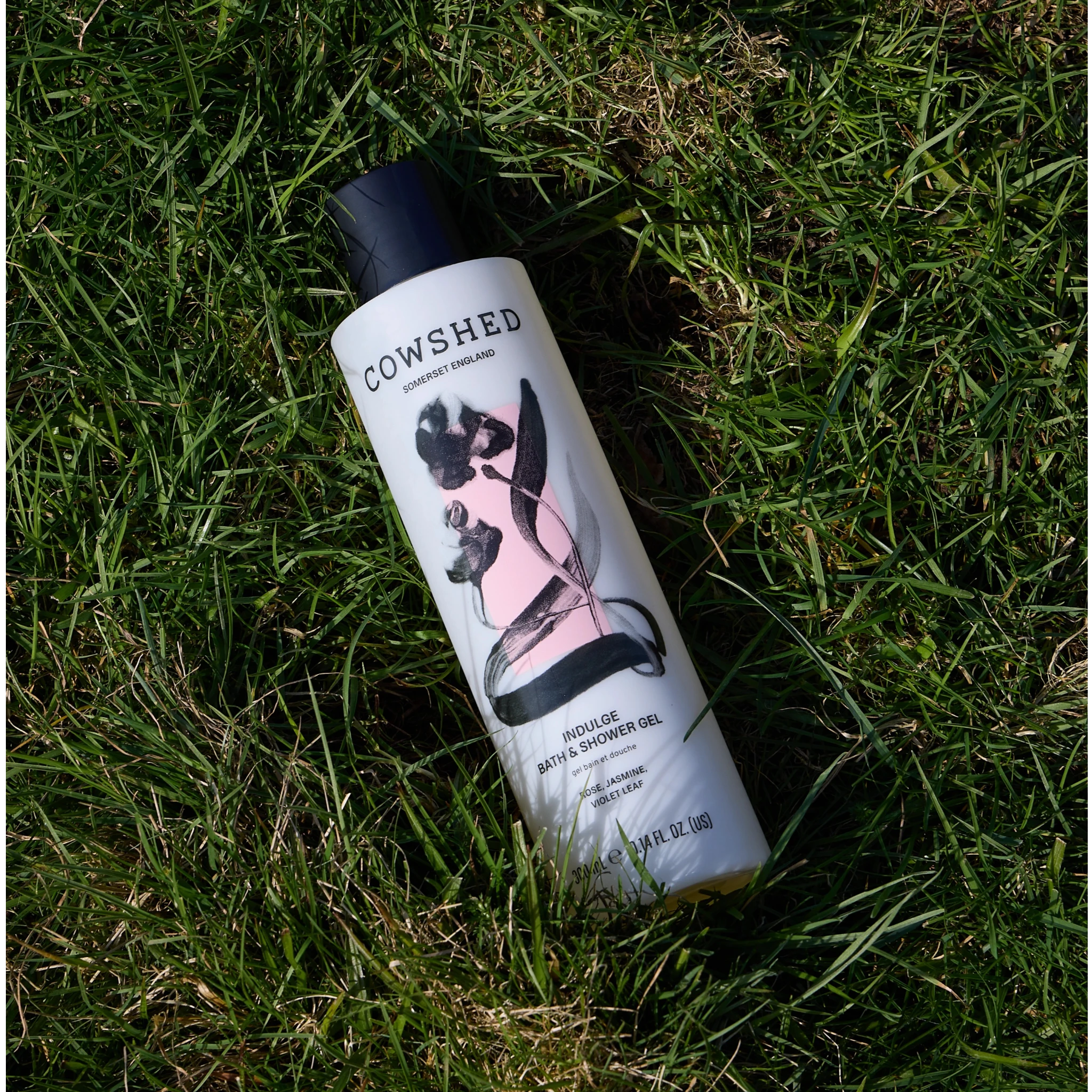 Cowshed Indulge bath and shower gel amongst grass