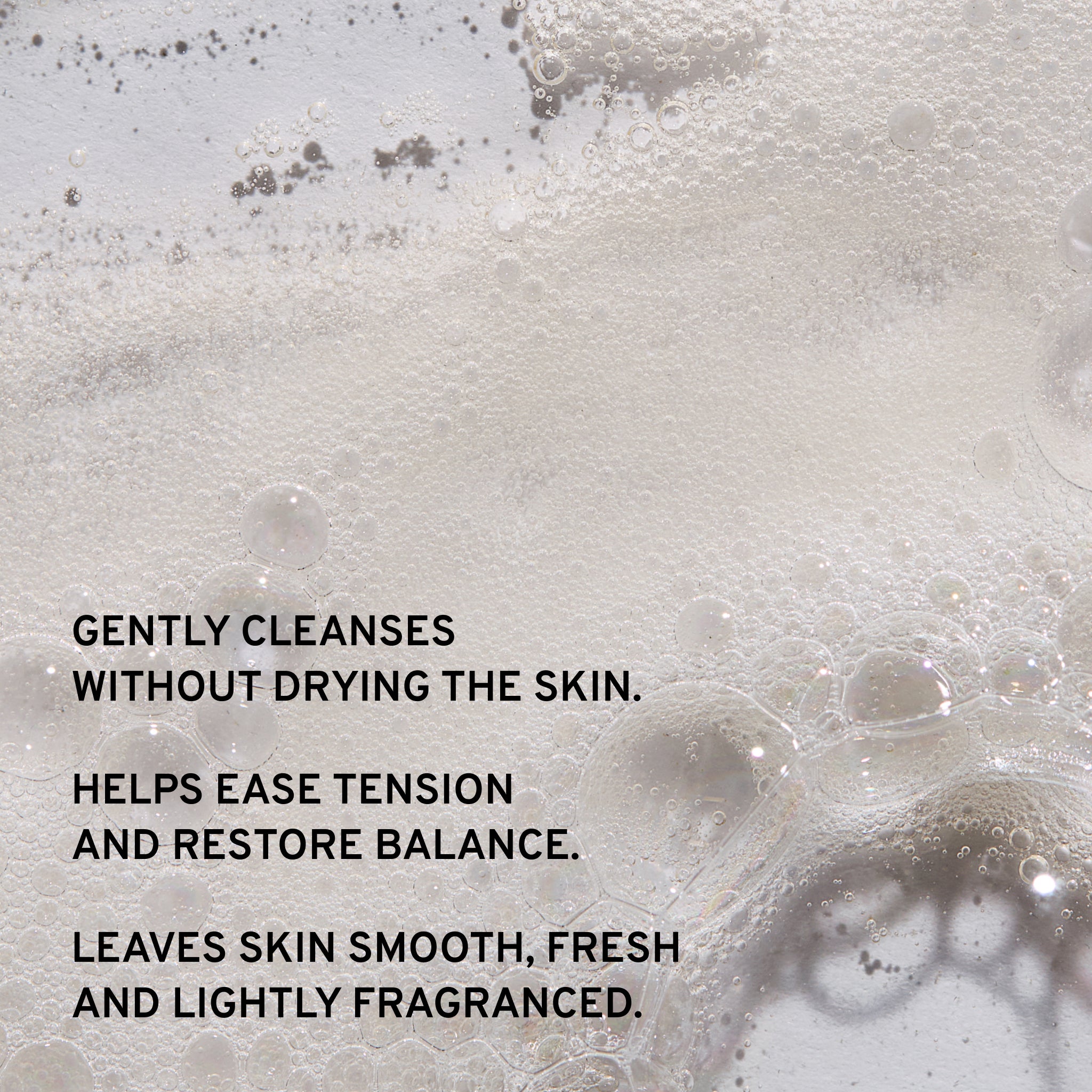 Foamy liquid with bubbles and text describing skincare benefits, gently cleanses without drying the skin