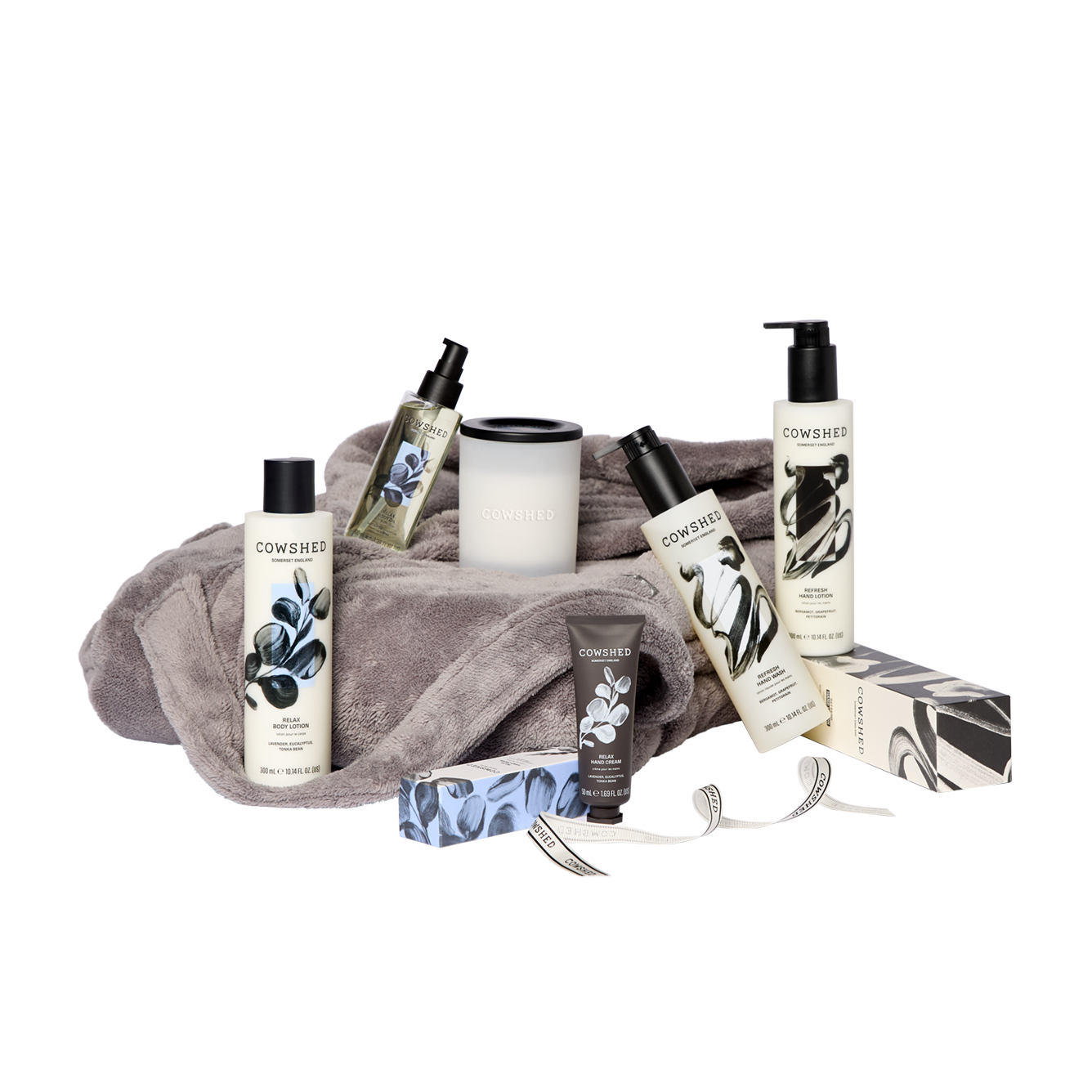 Cowshed skincare products including bottles, a towel, and a box on a white background