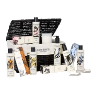 Cowshed product set including bottles, a bag, and other items on a white background