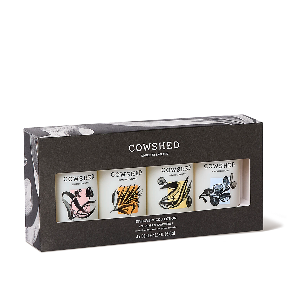 Cowshed Discovery Collection 4-piece bath and shower gold gift set in a dark gray box with a clear window showing four illustrated bottles.