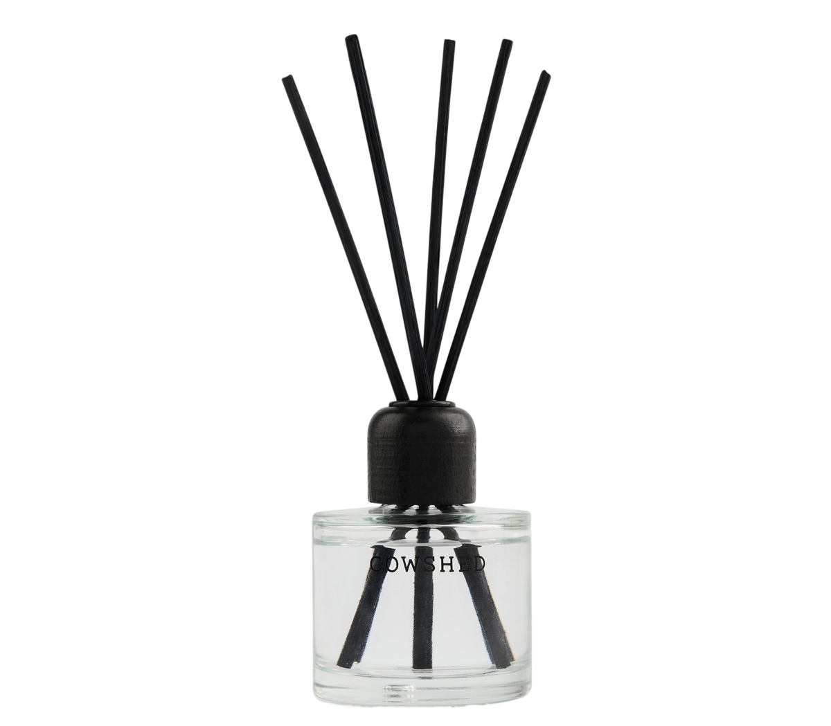 A reed diffuser with a clear glass bottle, black cap, and six black reeds, shown on a plain white background.