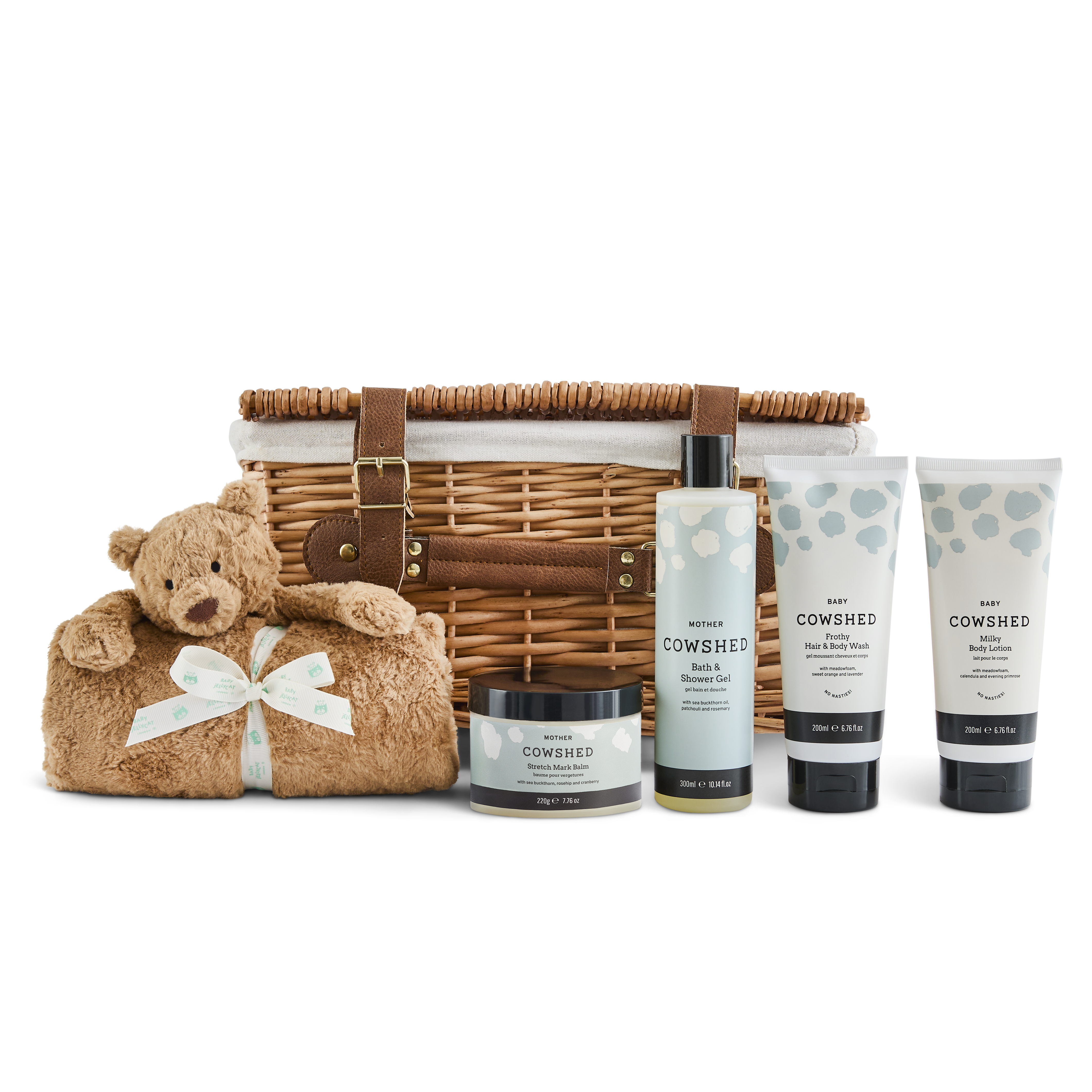 Baby gift set with wicker basket, teddy bear, and Cowshed baby products on a white background