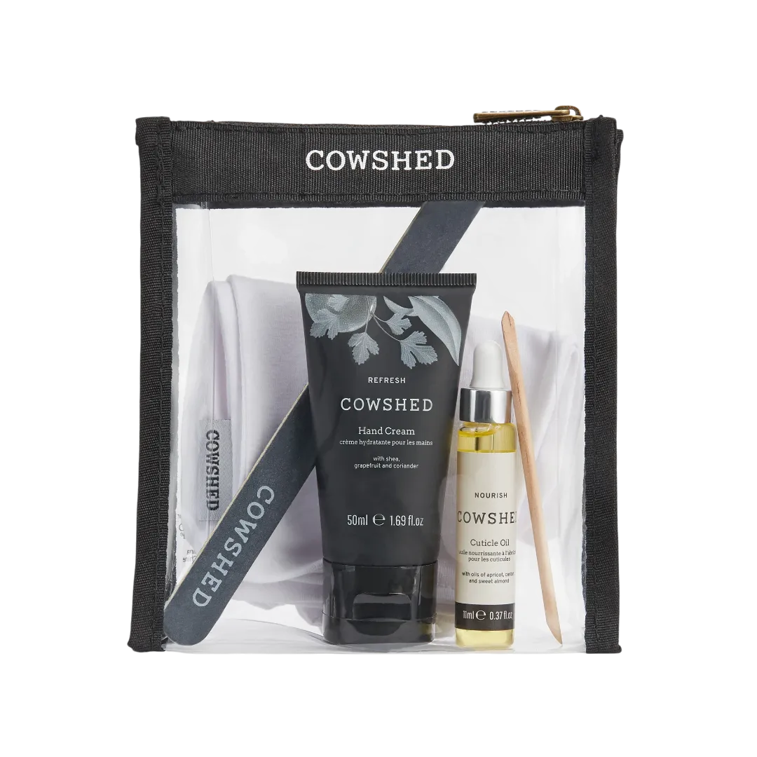 Cowshed skincare set with hand cream, serum, and brush in a clear pouch on a white background
