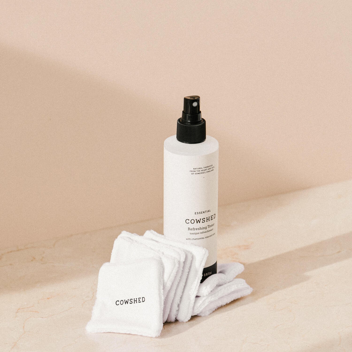 Cowshed skincare products on a beige background