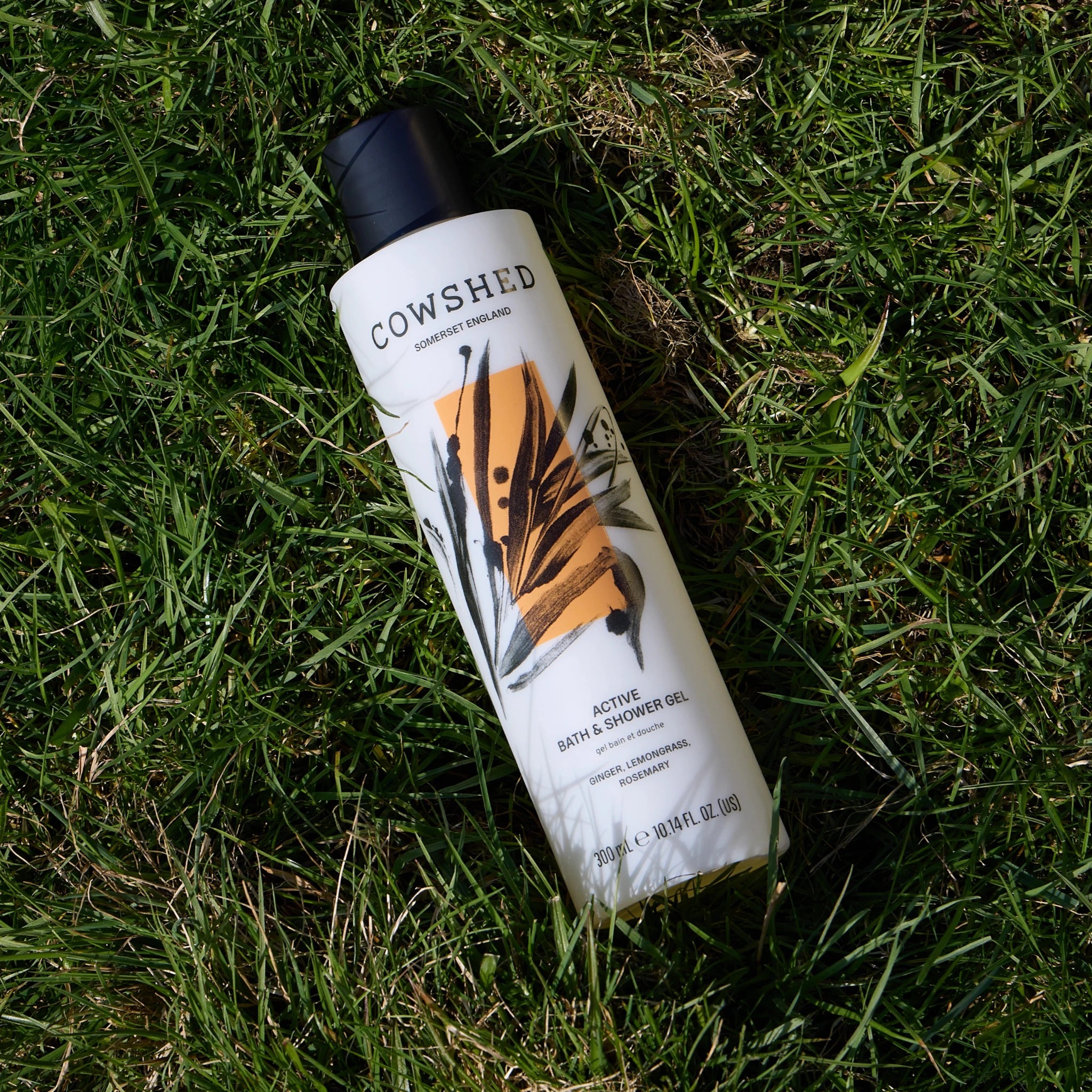 Cowshed Active 300ml shower gel on grass