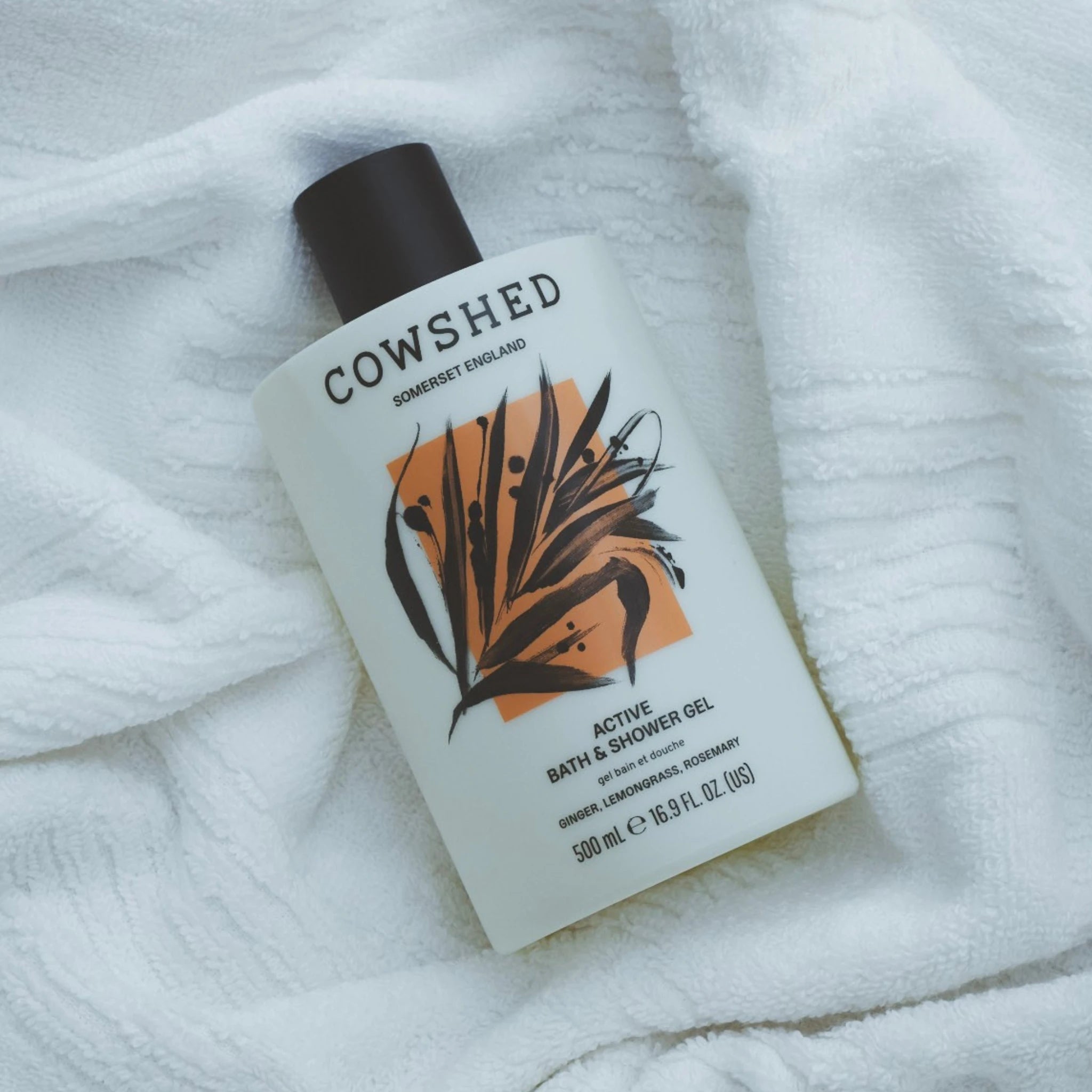 Cowshed Active Bath & Shower Gel bottle on a white towel
