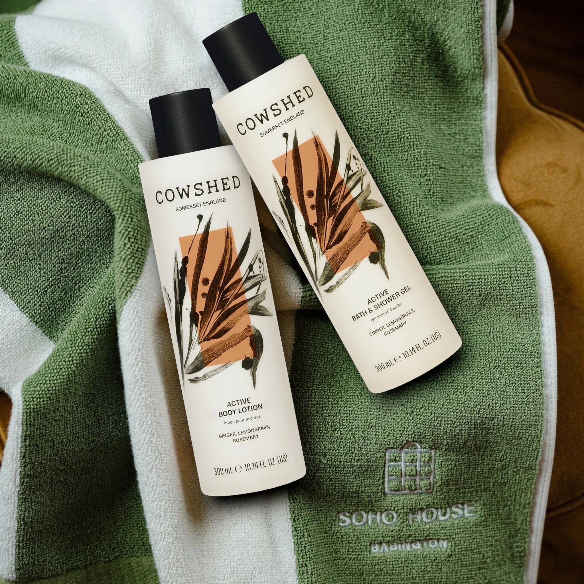 Two Cowshed Active bath & body products on a green towel with 'Soho House' branding