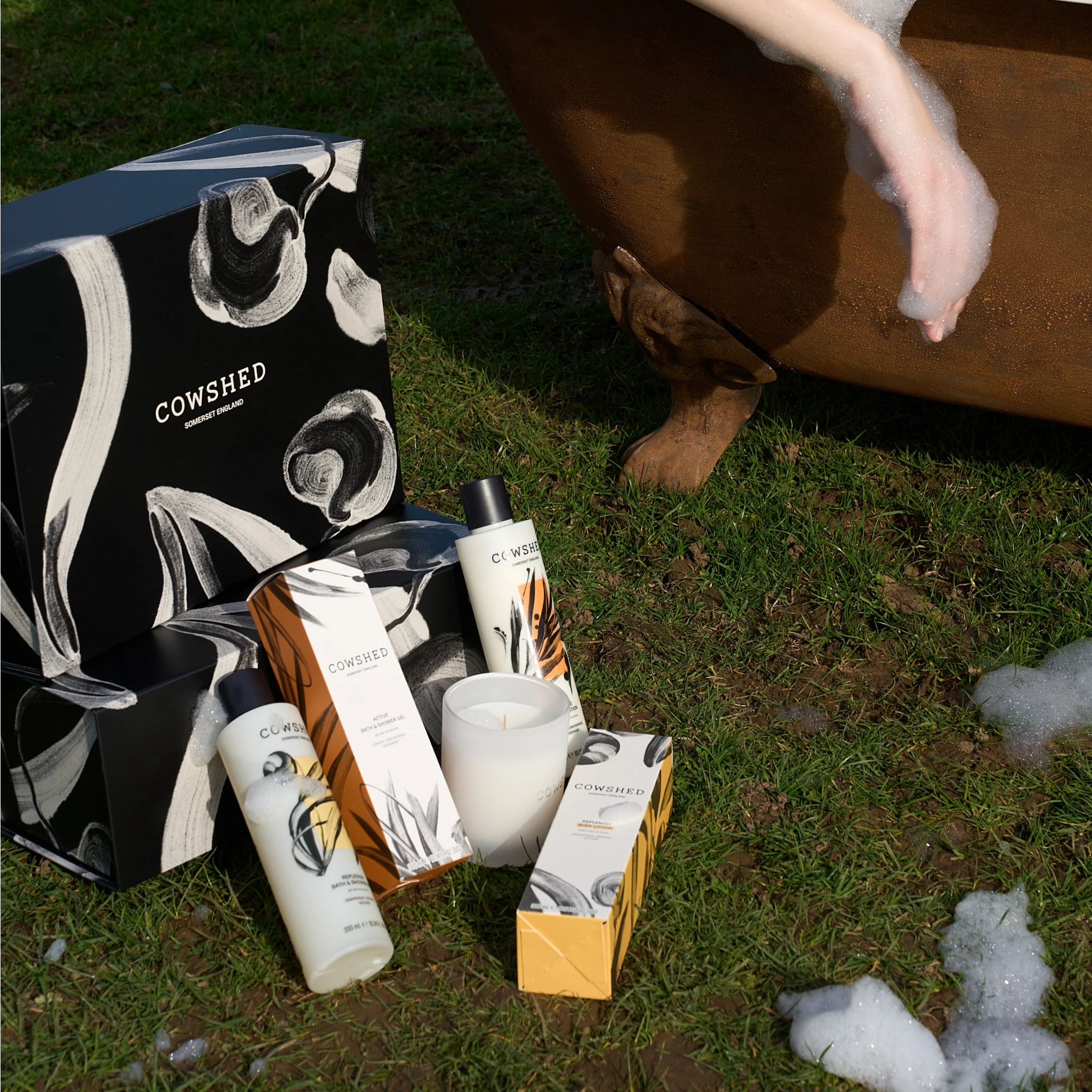 Cowshed product display on grass with a dog in the background