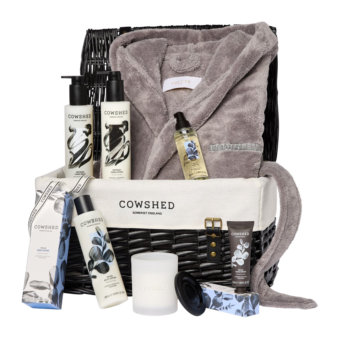 Cowshed product set with bathrobe and candles on a white background