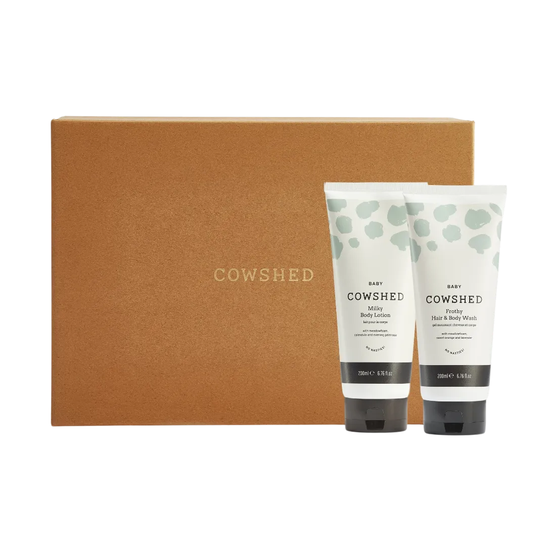 Two Cowshed baby products in front of a brown box with 'Cowshed' branding.