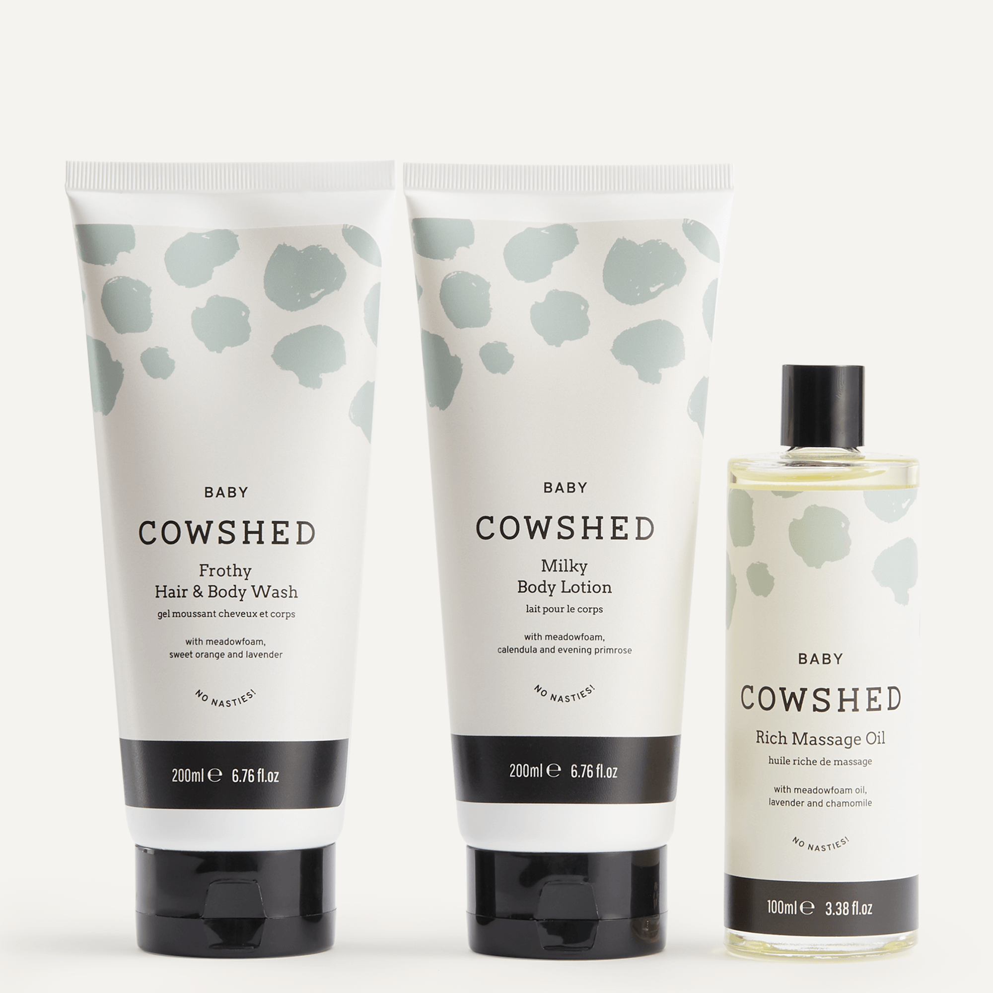 Cowshed baby skincare products including hair and body wash, lotion, and massage oil on a white background