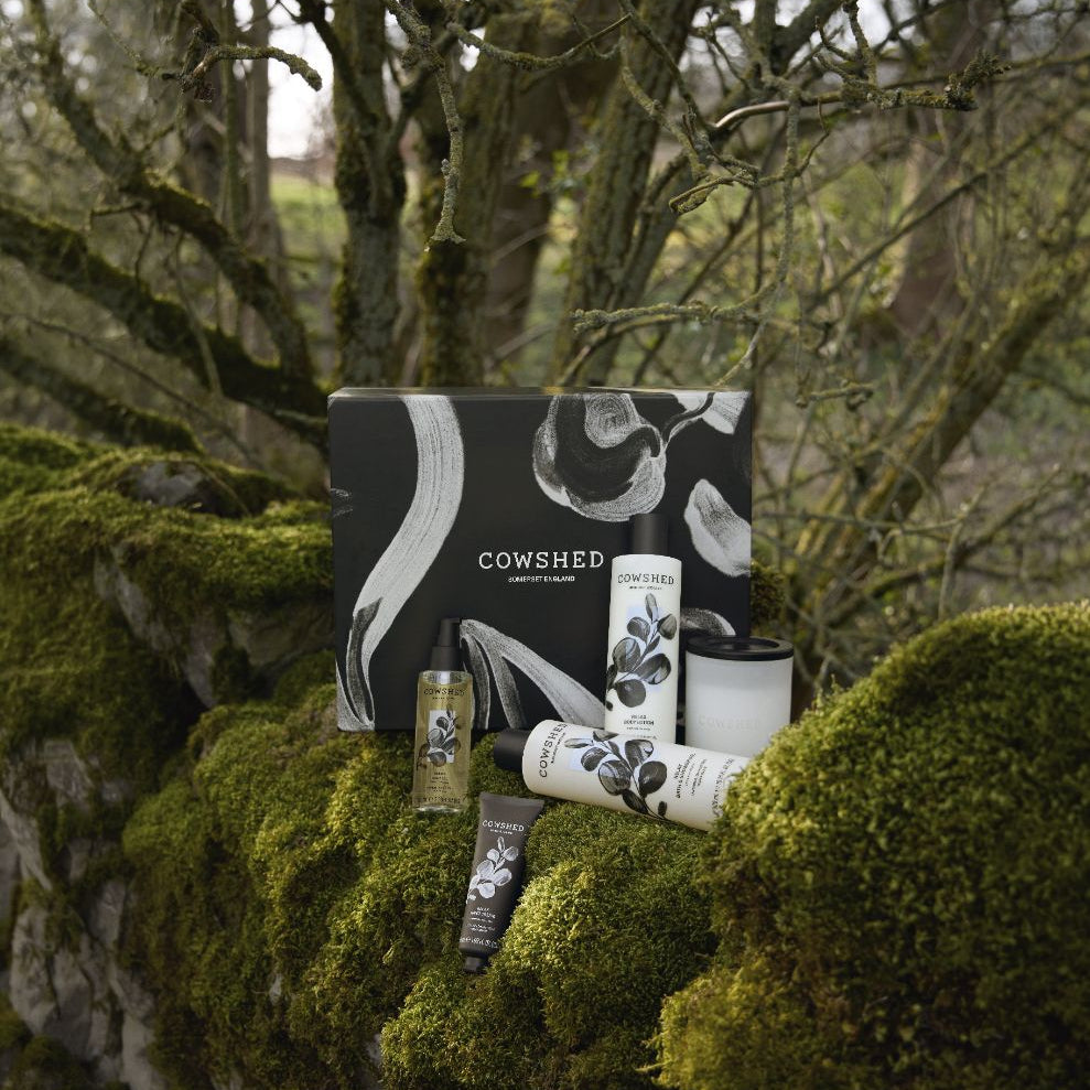 Cowshed product set on a mossy stone wall with trees in the background